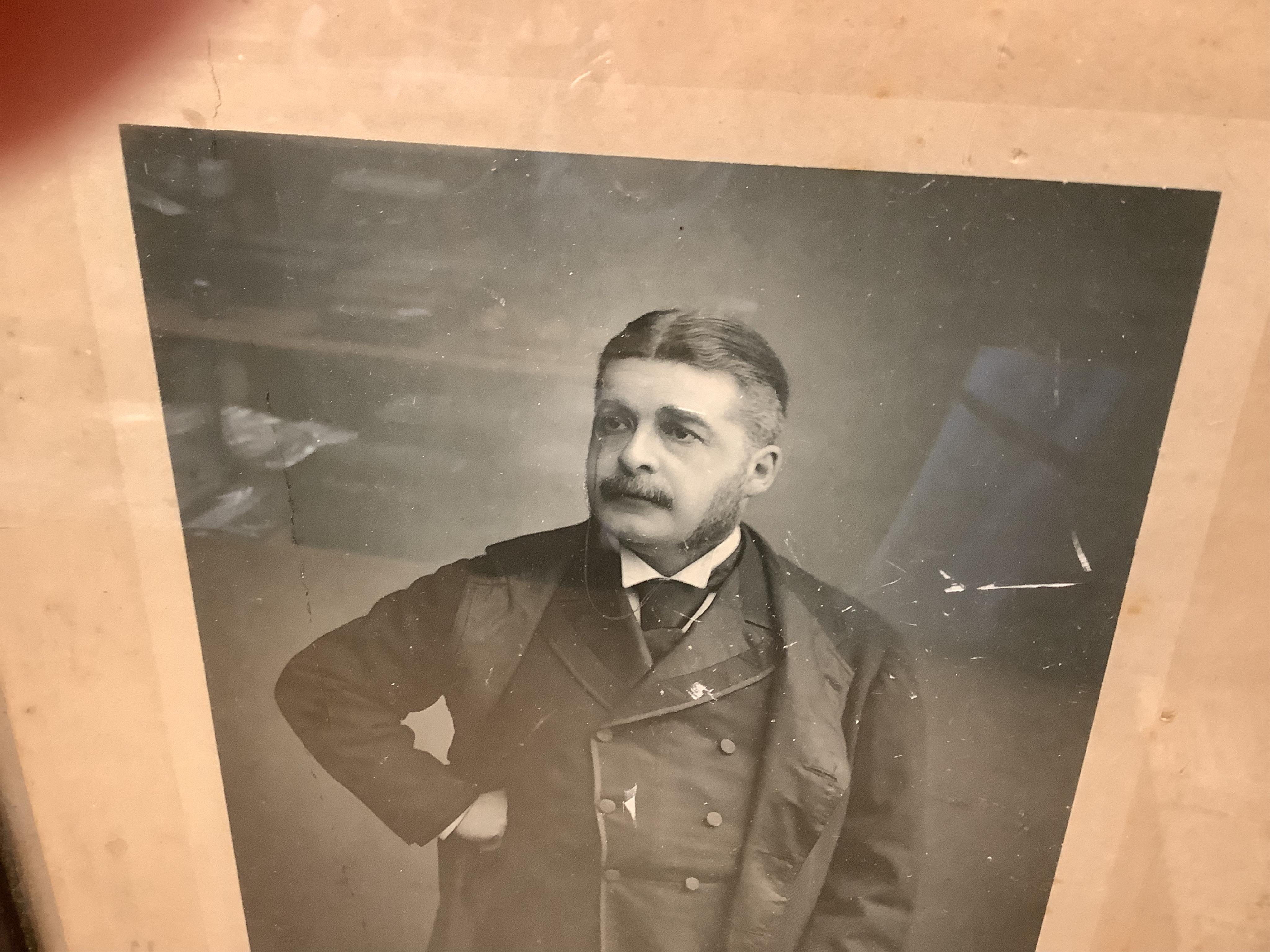 A Gilbert and Sullivan Opera model theatre, with printed card figures from the Mikado, together with a portrait photograph of Sir Arthur Sullivan loosely contained within a stained wood frame, the photograph is unmounted
